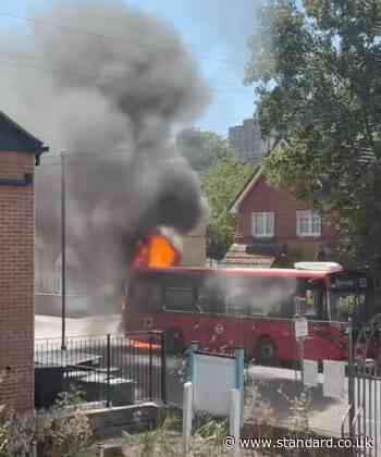 Moment bus bursts into flames on London street as firefighters rush to the scene