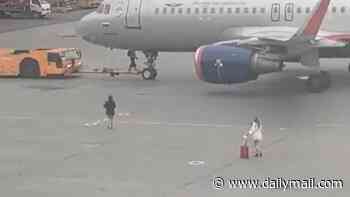 Moment 'passengers run across tarmac in desperate bid to catch flight' before they are escorted away