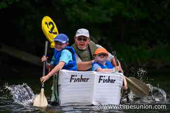 Photos: Paddlers sink, soar through cardboard boat race