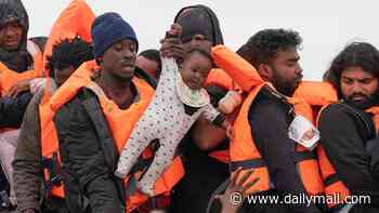 French police stand and watch as months-old baby is carried aboard a packed dinghy headed for Britain