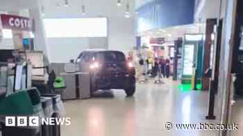 Moment raiders drive car into service station