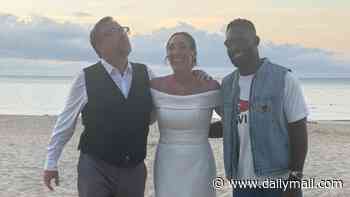 Tinie Tempah turns wedding crasher as he poses for photos with a bride and groom on the beach in Cornwall after performing at Boardmasters
