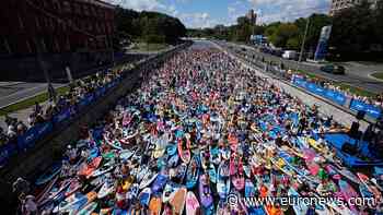 Costumed paddleboarders float down Moscow river in carnival