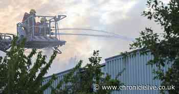 Photos of firefighters battling Washington fire at industrial estate with huge plumes of smoke