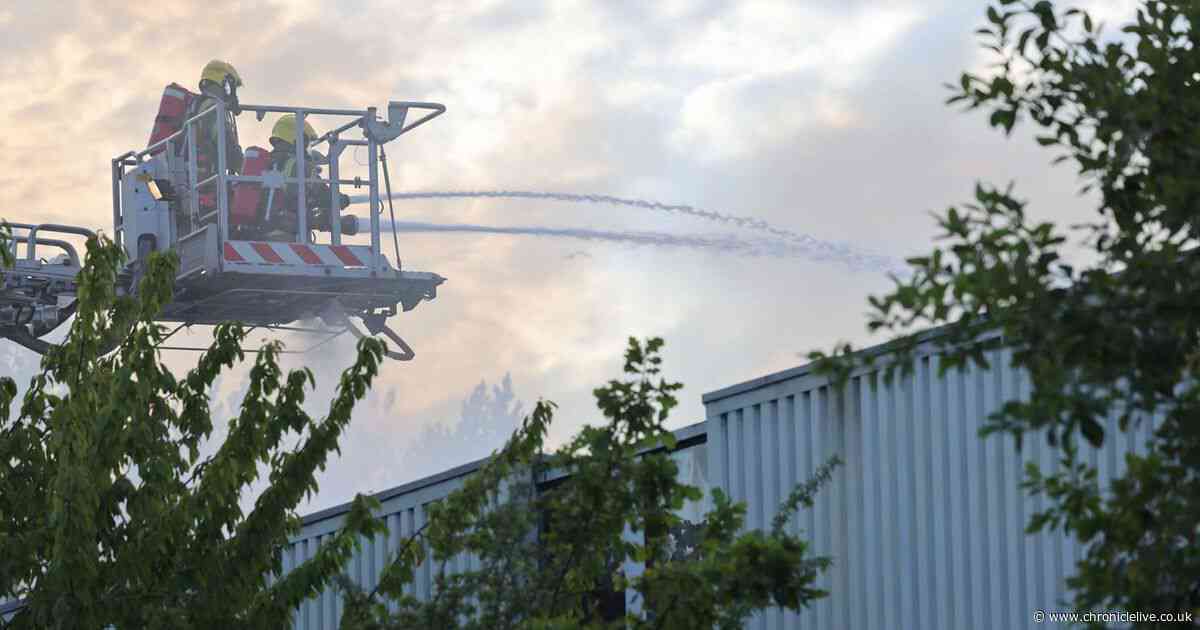 Photos of firefighters battling Washington fire at industrial estate with huge plumes of smoke