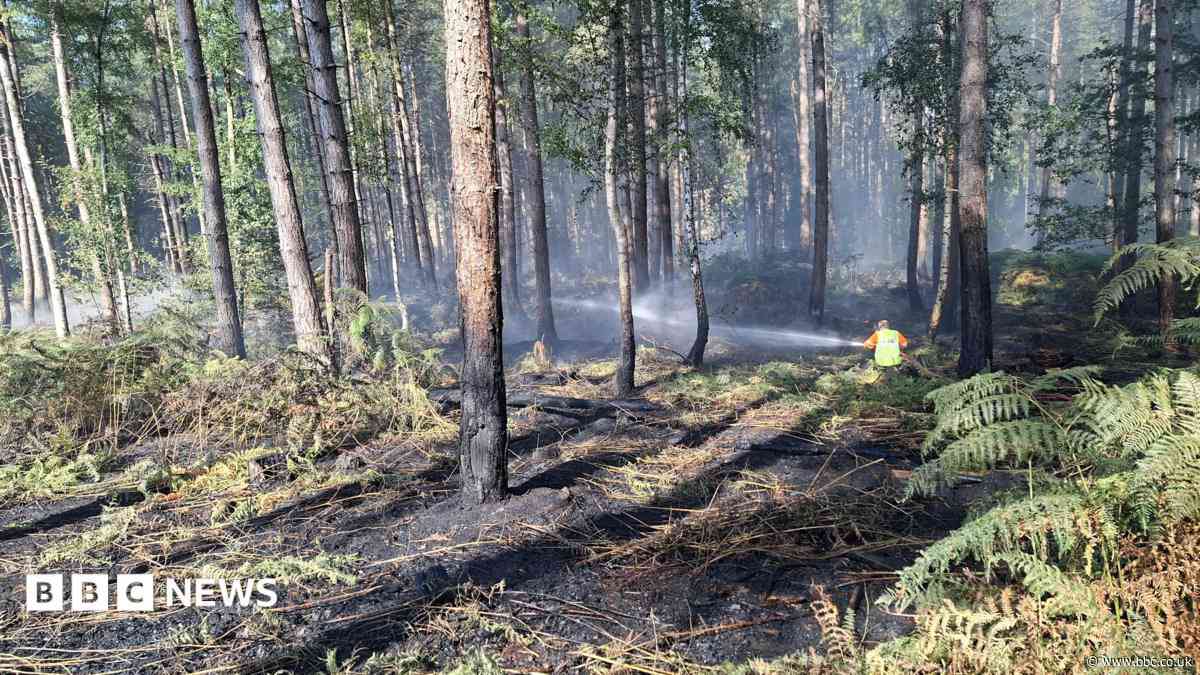 Crews tackling 'fire in the open' near village