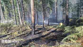 Crews tackling 'fire in the open' near village