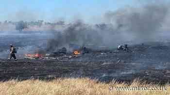 Two killed in helicopter crash as homes evacuated and incident sparks wildfire
