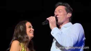 Hugh Jackman and girlfriend Sutton Foster are roasted as they perform a cringeworthy loved-up duet on stage: 'The cheese is too much'