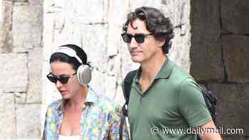 Katy Perry and Justin Trudeau hold hands while touching down in Sardinia as lavish European vacation stretches into THIRD WEEK