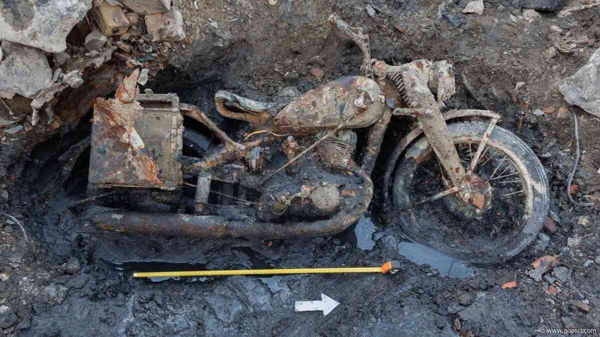 WWII motorcycle and soldiers emerge from river muck in Hungary