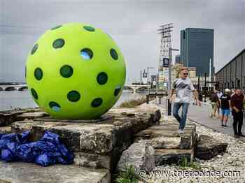 30 times larger than life, a glass pickleball sculpture serves the riverfront
