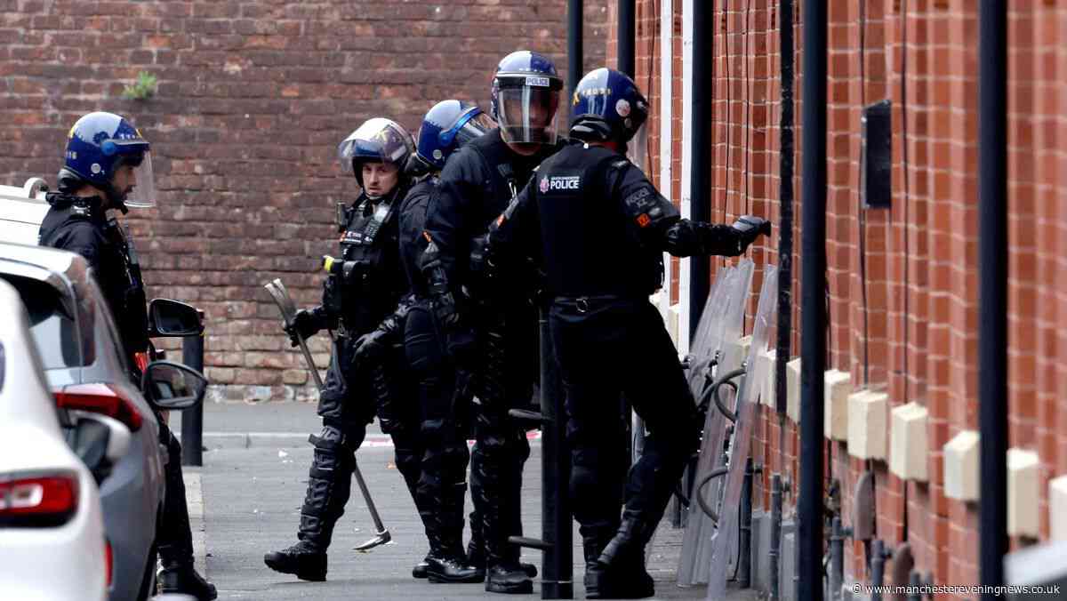 Riot police descend on Salford street with man in 36-hour rooftop stand-off