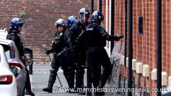 Riot police descend on Salford street with man in 36-hour rooftop stand-off