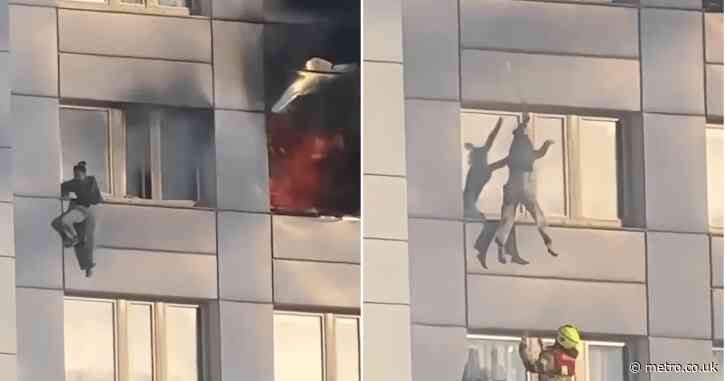 Moment woman jumps from burning 11th-floor building