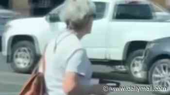 Moment Arizona grandmother pulls a GUN on alleged shoplifter while confronting him during tense parking lot standoff
