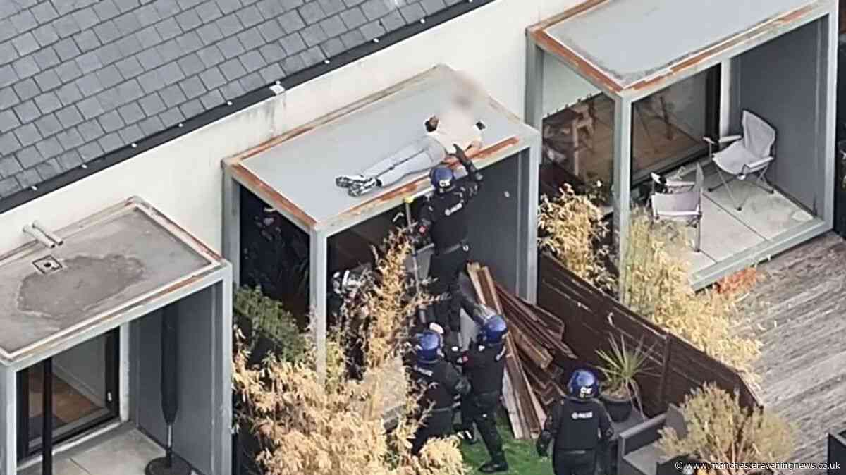 Drone footage captures cops dragging sleeping suspect from a roof following 48-hour stand-off