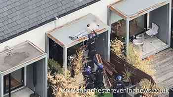 Drone footage captures cops dragging sleeping suspect from a roof following 48-hour stand-off