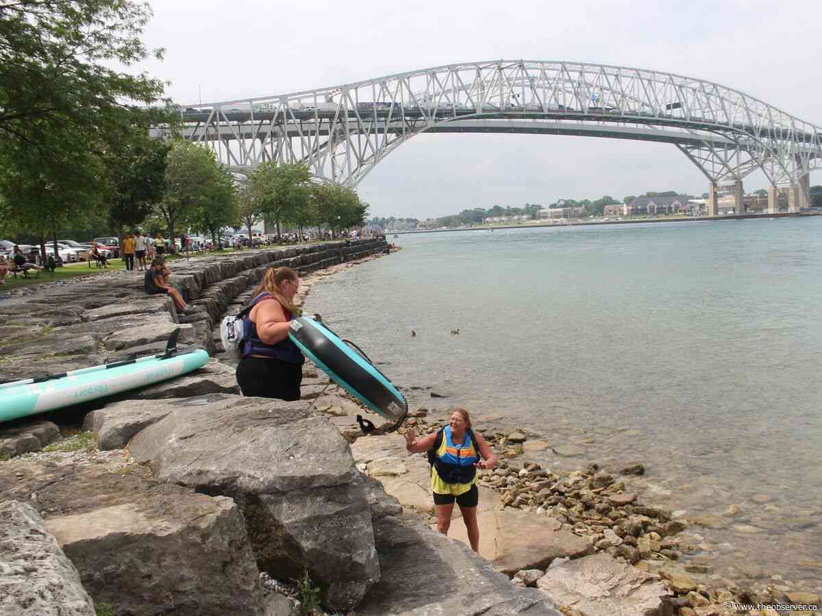 Hundreds wave off threatening weather and official warnings to join St. Clair River float down