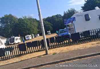 Travellers set up encampment in open space