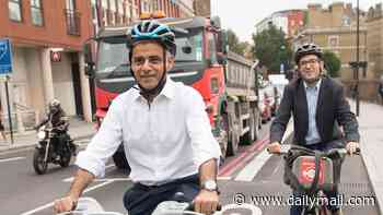 Moment pedestrians narrowly avoid being run down by cyclists who fail to stop for bike lane zebra crossing at one of Sadiq Khan's 'floating bus stops'