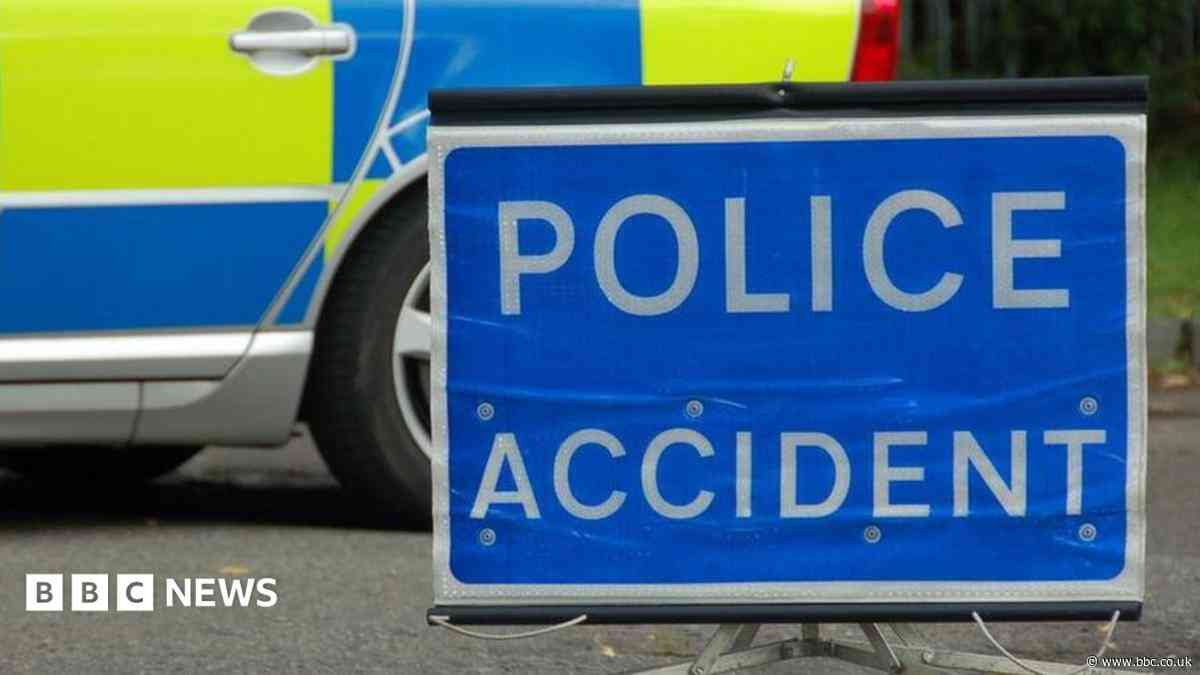 Woman dies after falling from bridge on to A-road