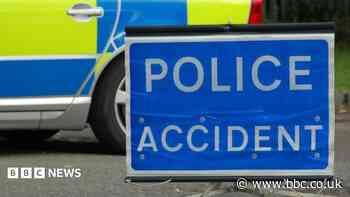 Woman dies after falling from bridge on to A-road