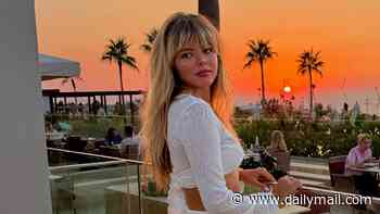 Amanda Holden's daughter Lexi Hughes stuns in a white ab-flashing crop top and maxi skirt as she shares sunset photos from her holiday