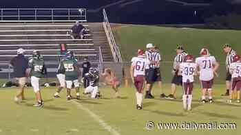 Shocking moment 16-year-old girl storms field and tackles middle school football player... before being hit with assault charges and lifetime ban