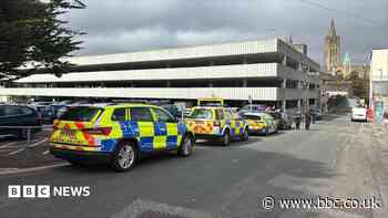 Man arrested  after body found in car park