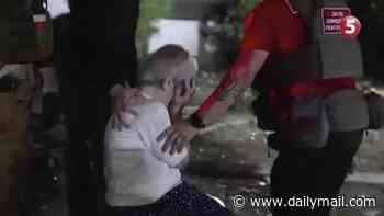 A grandmother's tragedy: Heartbroken Ukrainian looks on as her grandson's body is pulled from rubble after Russian missile hits apartment block
