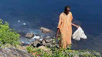 Outrage after man is filmed doing LAUNDRY in scenic Maine river and filling its waters with detergent that's toxic to nature