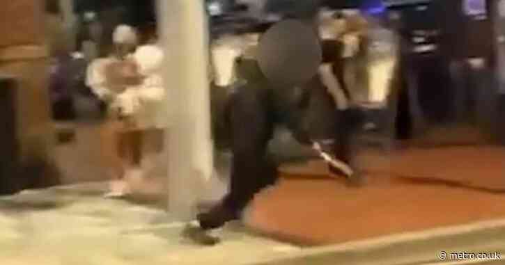 Teen wielding a machete chases man through street packed with people outside bars