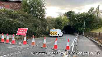 Main road in Wigan blocked off after flooding as car 'abandoned'