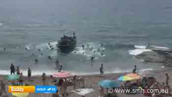 Migrant boat reaches Spanish tourist beach