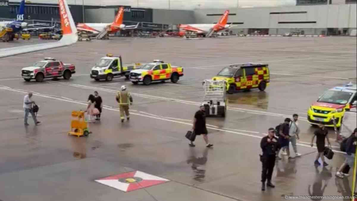 EasyJet plane met by fire engines at Manchester Airport as passengers taken off flight