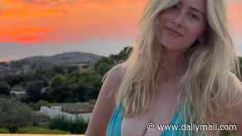 Clementine Vaughn, 21, is the spitting image of model mother Claudia Schiffer, 55, as she poses in a low-cut turquoise swimsuit while on holiday in Greece