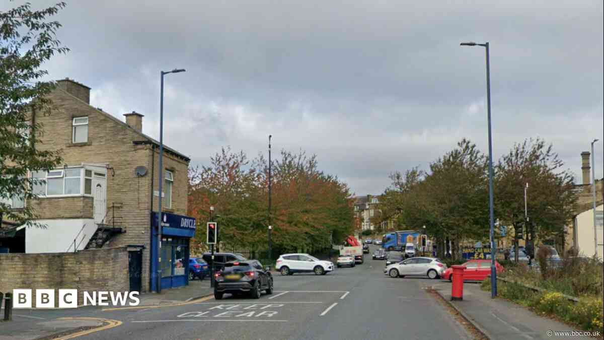 Man arrested over crash between ambulance and car