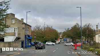 Man arrested over crash between ambulance and car