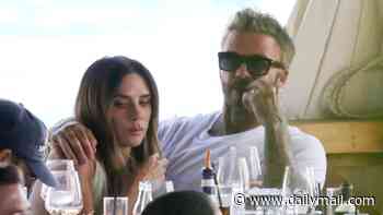 Victoria Beckham shows off her bikini under sheer mint green dress as she shares sweet PDA with husband David on her during family dinner in Italy