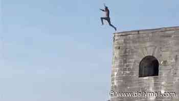 Moment daredevils are caught tombstoning into shallow water as they run and jump off 20ft high sea walls