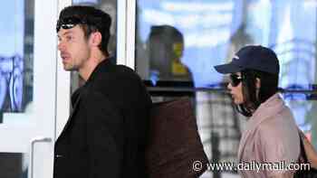 Harry Styles looks smart in a black suit as he touches down in New York with fiancée Zoe Kravitz ahead of his 30-date residency in Madison Square Garden