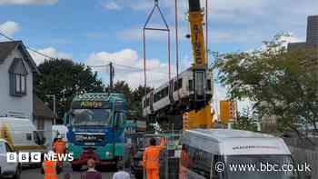 Derailed carriages are swept for passengers' bags