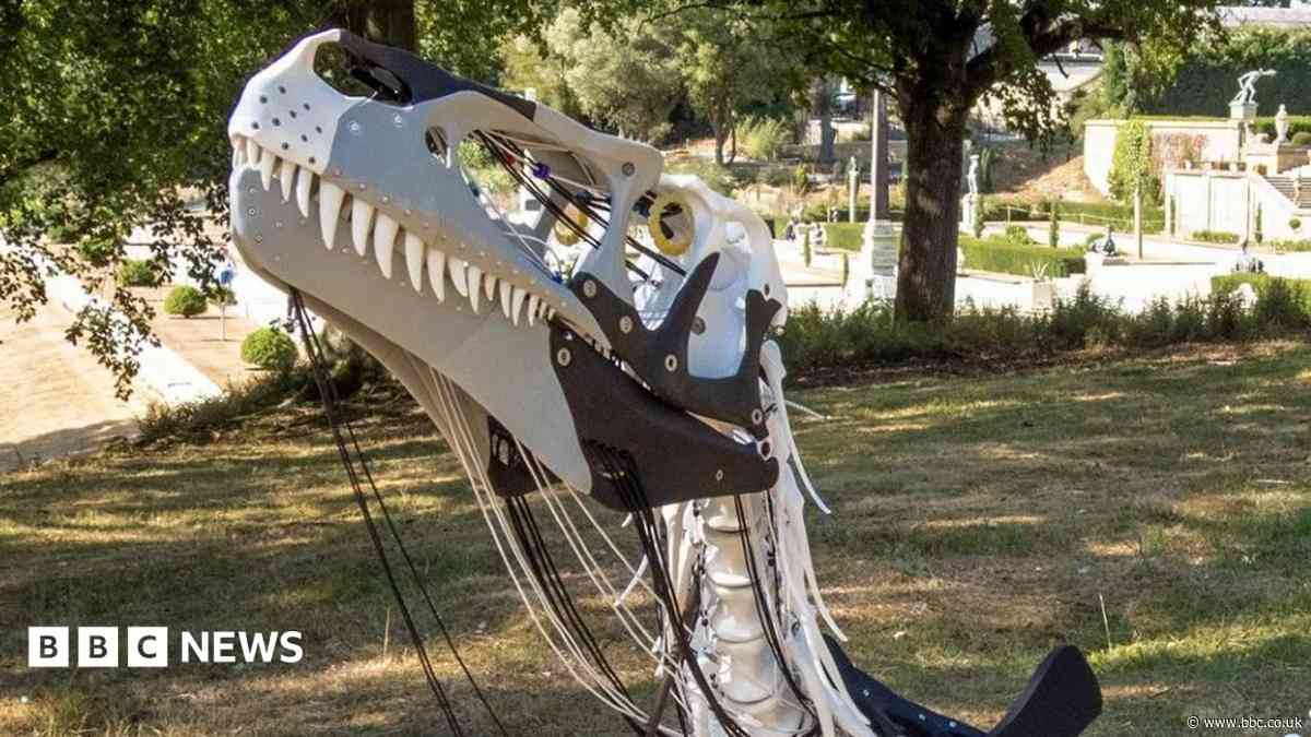 Life-size dinosaur sculptures displayed at palace