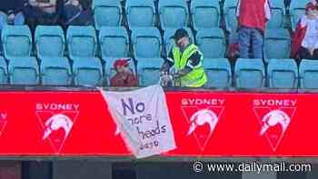 Strong crowds turn out as Sydney Swans hit field for first time since alleged sexual assault probe - but some fans walk out: 'Respect women'
