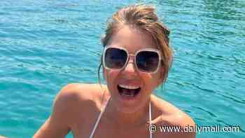 Elizabeth Hurley, 61, displays her incredible figure in a white bikini as she kicks back on a summer holiday in 'paradise' with friends