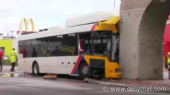Driver seriously injured after bus crashed into a rail bridge, trapping him in the wreckage
