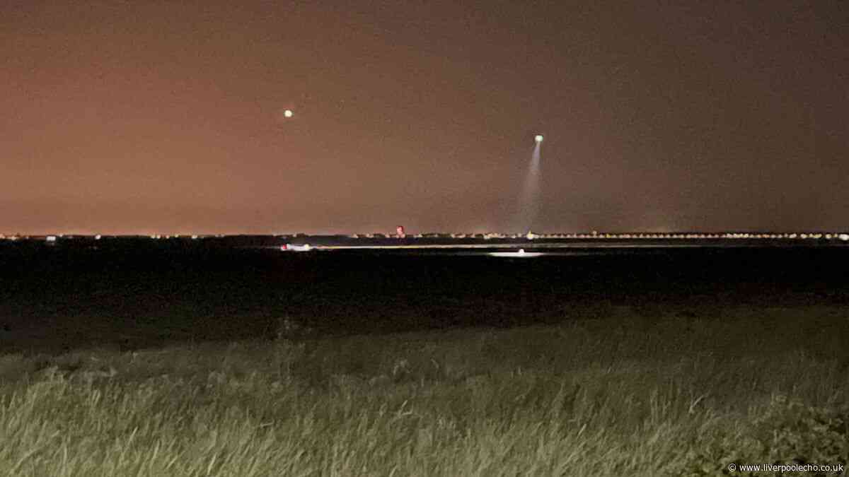 Emergency services scour Merseyside beach in hunt for two people