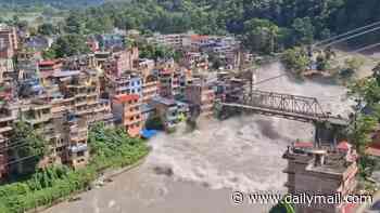 Hundreds of tourists missing including 12 Brits as flash flood triggered by earthquake sweeps away buildings and bridges in Nepal 