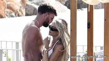 Love Island's Molly Smith embraces her bridal era in a white thong bikini as she cuddles shirtless husband Tom Clare at a Mallorca beach club after their boozy wedding